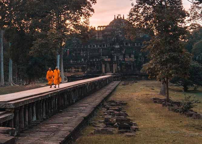 Baphuon Temple, Monk walking out on causeway during sunset